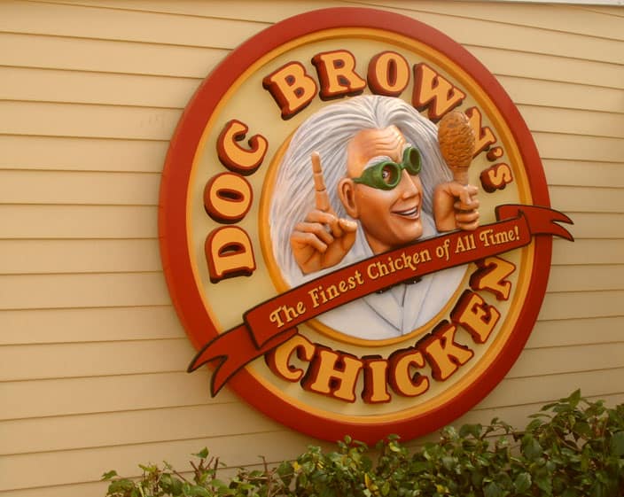 A photograph of a food restaurant's sign called Doc Browns Chicken