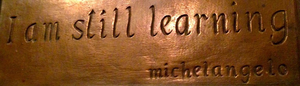 Photograph of a small plaque that says "I am still learning", a quote from Michelangelo