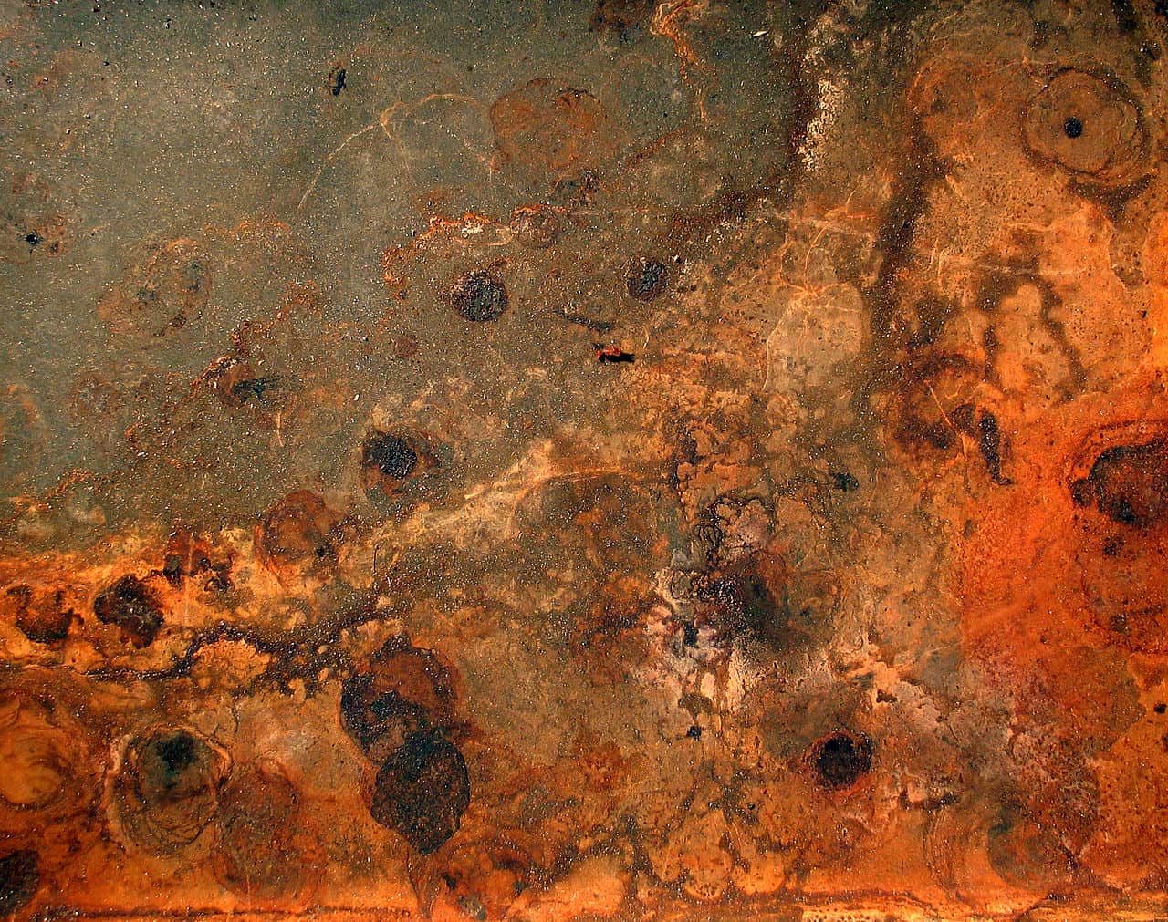 A photograph of rust and dirt.