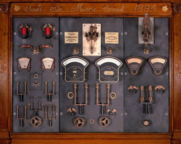 Photograph of a switchboard panel with many levers and knobs.